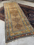 Camel ground antique wool runner with tribal energy and warm earthy coloration.