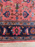 1920s Persian area rug detail highlighting the soft wool pile and intricate midnight blue border work.