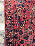 Closeup of Sarouk rug edge showing secured sides. a patch, and aged character from the 1930s.