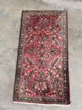 Small 1930s Sarouk rug with floral sprays and sheen.