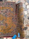 Antique 1930s Persian Sarouk rug underside view of old underlayer residue and weave texture.