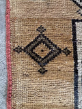 Close up of border detail of a Northwest Persian Serab rug with sporadic motif placement.