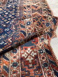 Texture of vegetable dyed wool with low pile and age.