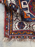 Detail of tribal motifs woven throughout Persian Shiraz rug.