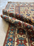 Antique vegetable dyed wool rug with tribal motifs and worn in patina.