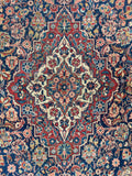 Navy blue and red antique Persian Tabriz accent rug with intricate foliate artwork.