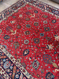 1920s Tabriz rug featuring an all-over floral design with vases and vines.