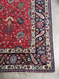 Corner view of vintage Tabriz rug showing botanical pattern and color story.