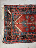 Antique Caucasian geometric runner with rust, sky blue, and tribal motifs, hand knotted in the early 1900s.