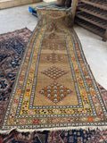 Antique tribal runner with camel ground and geometric diamond motifs, approximately 4x10.