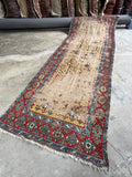 Antique Caucasian runner, hand knotted vegetable dyed wool hallway rug with a worn ivory field, tribal geometric motifs, and authentic farmhouse character.