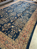 Antique 1920s Turkish Sparta rug with a deep navy ground and sprawling floral vine design.