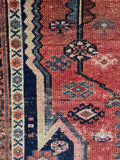 Distressed vegetable dyed wool rug close-up detailing authentic low pile and vegetable dyed wool.