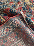 Underside view of 1920s antique Persian Malayer rug, handmade with vegetable dyed wool.