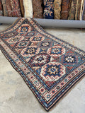 Antique Caucasian Kazak runner rug with geometric star medallions and vegetable dyed wool.