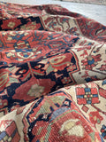 Handwoven antique Persian rug with mellowed vegetable dyed wool and intricate design.