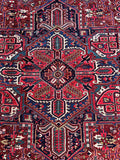 Antique Heriz rug. Hand knotted Persian wool carpet with bold tribal design, saturated natural colors, and minimal wear.