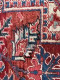 Antique Persian Heriz rug. Full-pile wool carpet featuring bold tribal motifs, vegetable-dyed wool, and minimal age-related wear.