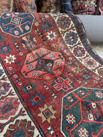 Antique wool runner featuring tribal symbols and designs.