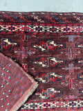 Yomut tribal bag face detail close-up showing the fine knotting, geometric borders, and lustrous wool texture.