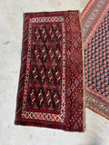 Yomut bag face textile featuring hand-knotted wool with rich lanolin sheen and detailed border work.