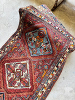 One end view of medallions and abstract geometric motifs.