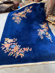 Antique 1930s Art Deco Chinese rug with royal blue ground and floral motifs.