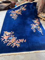 Antique 1930s Art Deco Chinese rug with royal blue ground and floral motifs.