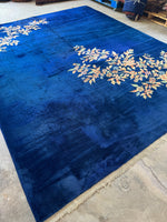 Royal blue antique Chinese rug featuring ombre floral designs in two corners.
