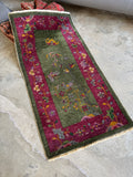 Small decorative antique rug with bird motifs, compact wool pile, and saturated jewel toned colors.