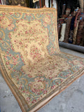 Romantic Aubusson flatwoven tapestry featuring soft mauve flowers and curving leafy vines.