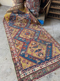 19th century Persian tribal rug measuring 4' x 7' with vibrant aqua blue, red, and yellow colors.