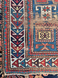 Circa 1900 Kazak rug woven with vegetable-dyed aqua blue wool and red mountain edge guard border.