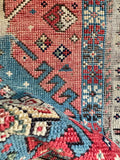 Caucasian village wool rug detailing hand-spun yarns, authentic abrash shifts, and antique tribal patterns.
