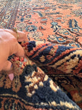 Handmade Antique Persian Rug featuring a coral pink field, floral sprays, healthy wool pile, and timeless Dargazine pattern.