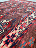 Antique Yomut accent rug displaying a classic Turkmen geometric pattern with crisp ivory and navy highlights.