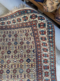 Corner view of vintage Caucasian Shirvan wool rug with all over tribal design and vegetable dyed wool.
