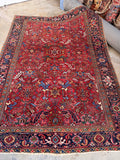 Antique Persian Heriz rug hand knotted red wool tribal area rug.