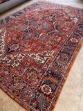Large antique Persian Heriz area rug featuring brick red, navy blue, ivory, and sky blue vegetable dyes.