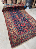 Kurdish rug decorated with classic Herati motif patterns in border.