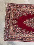 Multi generational antique Persian rug showcasing classic Persian Sarouk style and open layout.