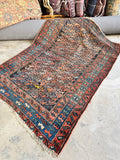 Antique Persian scatter rug 4x6 with worn vegetable dyed wool in faded coral and blue, handmade 1920s area rug for farmhouse interiors.