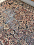 Timeworn Persian Mahal rug overhead shot capturing some of the geometric pattern layout.