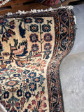 Vegetable dyed wool Lilihan door mat close-up image showing soft pinks, muted blue, and sage green floral accents.