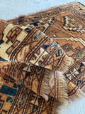 Narrow 1x4 vintage runner rug lying flat, showcasing rich brown, tan, and dark blue geometric tribal design.
