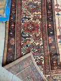 Blush ivory Persian area rug with vibrant aqua blue and charcoal accents throughout the border.