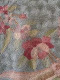 Close up view of antique floral Aubusson tapestry suitable for wall display or use on the floor.