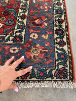 Corner of Persian Bakhtiari rug showing minor wool loss.