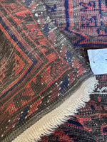 Underside view of antique Persian Baluch rug.