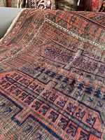 Close-up of Baluch rug border with geometric grid design symbolizing protection.